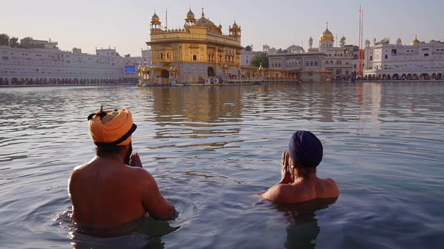 In Amritsar, India, Sikhs bathe by the Golden Temple